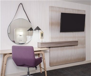 Hotel room with desk and mirror